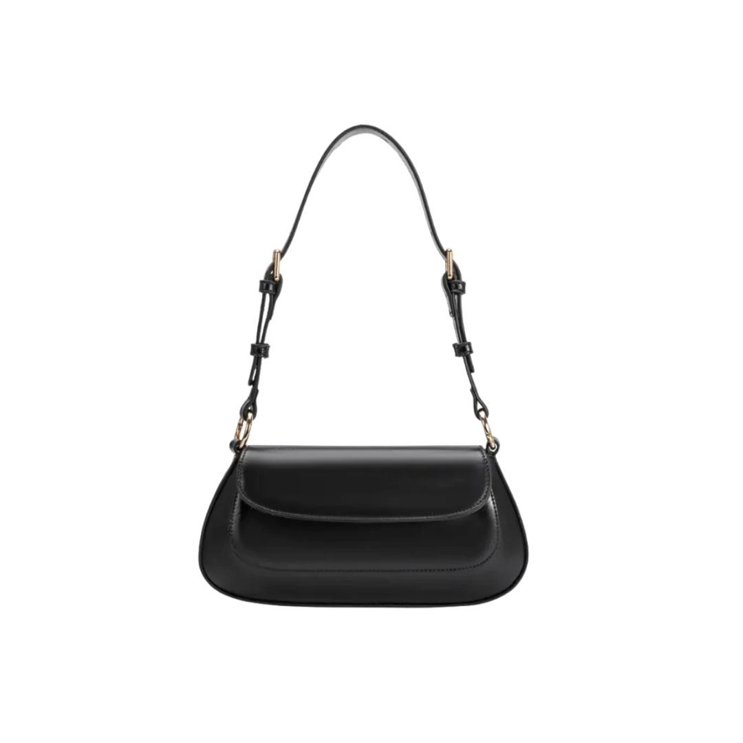 Black handbag with a strap on a white background