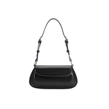 Black handbag with a strap on a white background