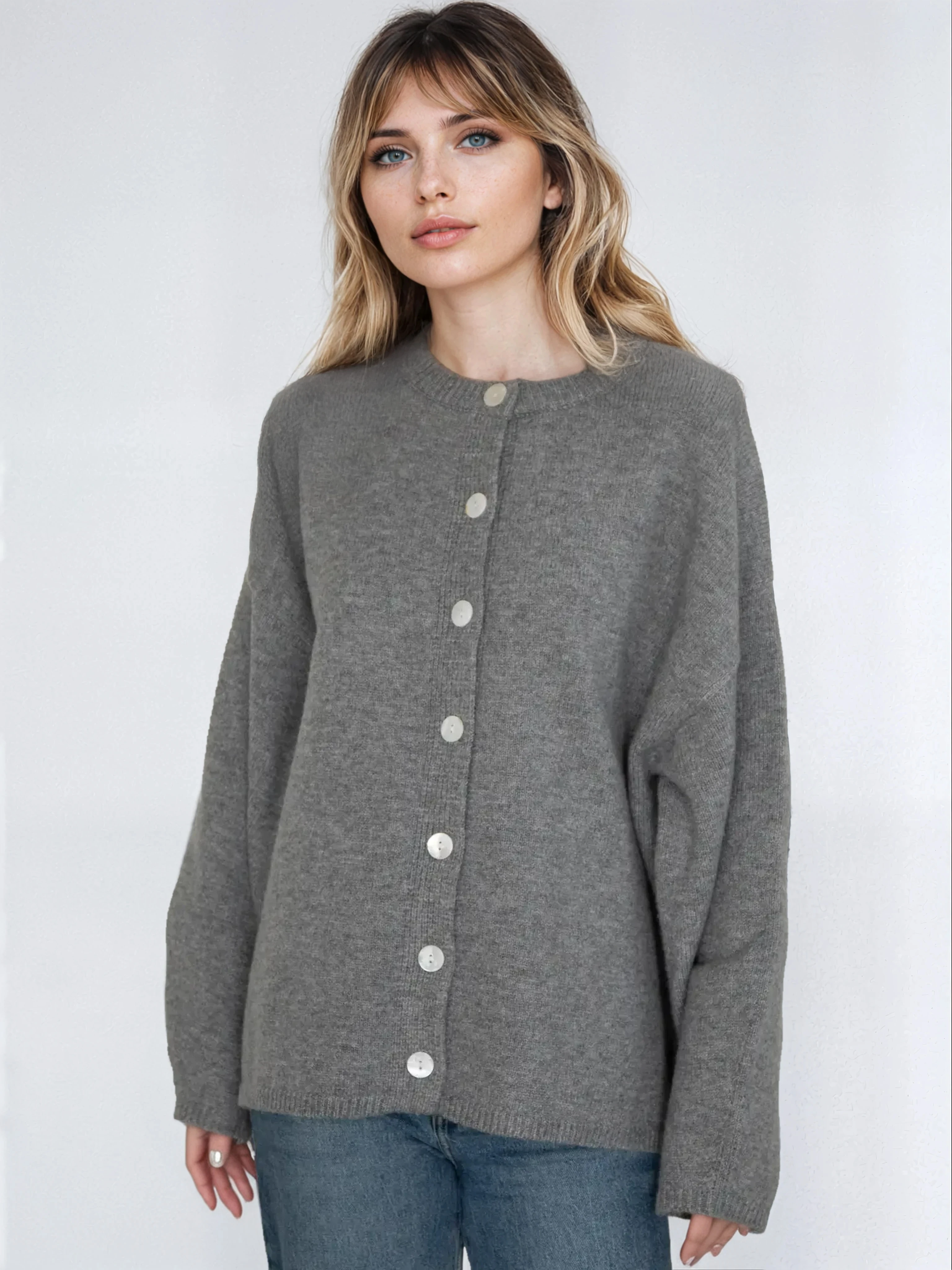 Woman wearing a gray cardigan with buttons on a white background