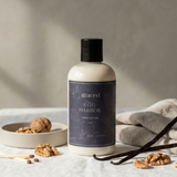 Bottle of 'Ego Harbor' hand lotion with vanilla beans and nuts on a neutral background