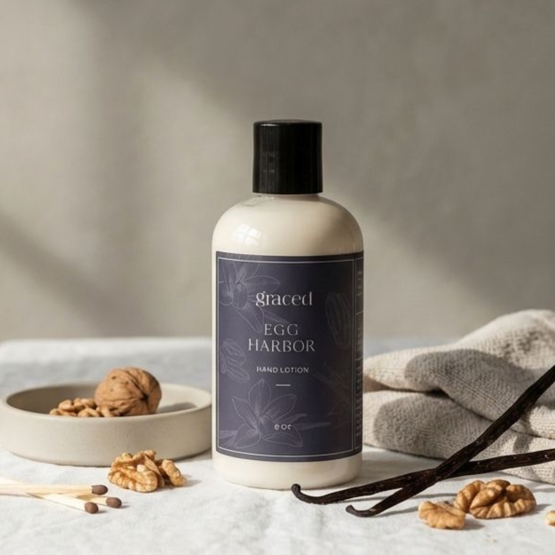 Bottle of 'Ego Harbor' hand lotion with vanilla beans and nuts on a neutral background