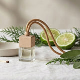 Table setting with a small plant, lime, and decorative item on a neutral background