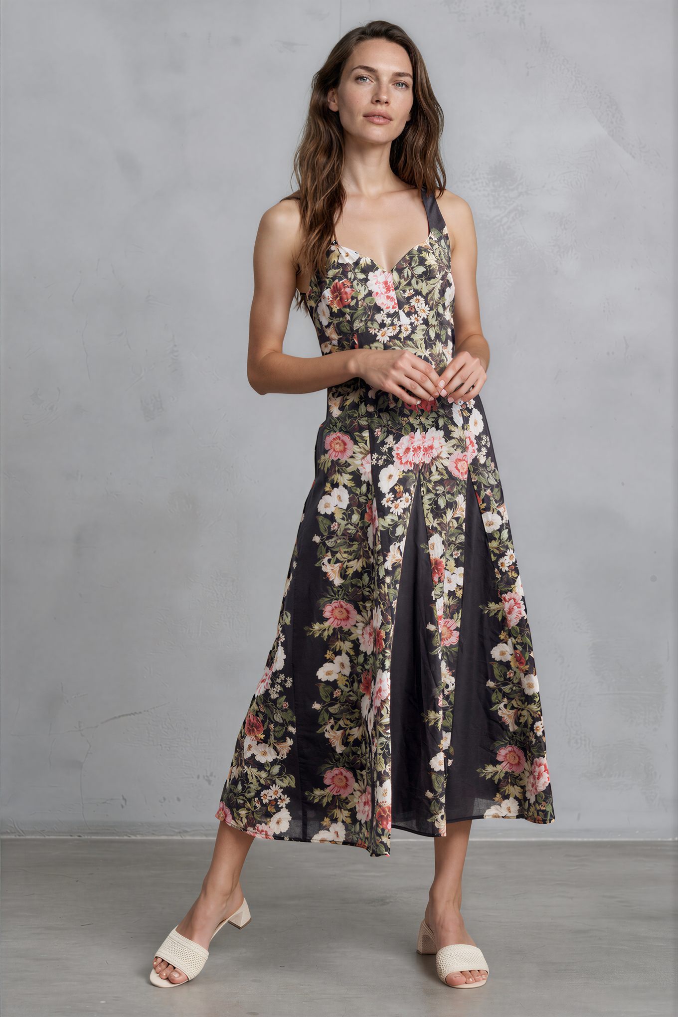 Woman wearing a floral dress against a gray background