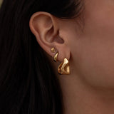Pair of ALCO Form Studs jewelry earrings featuring sleek, minimalist metal studs for a modern accessory look.