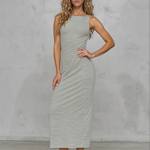 Woman wearing a striped dress against a plain background