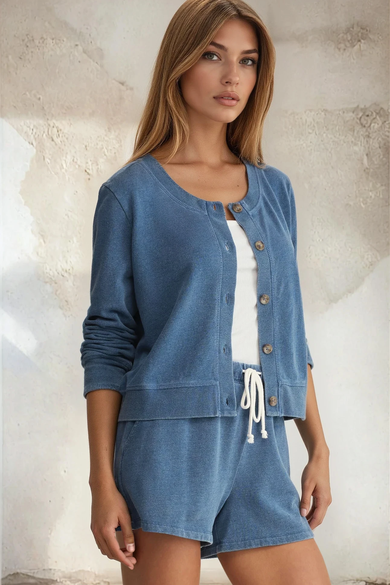 Woman wearing a blue denim outfit with a white background