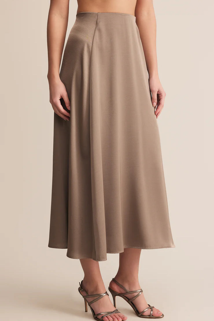 Woman wearing a beige skirt on a beige background