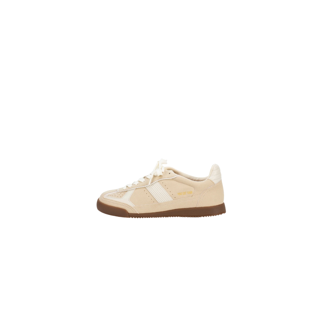 Beige sneaker with brown sole on a white background