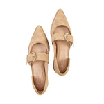 Pair of beige pointed-toe shoes with gold buckles on a white background
