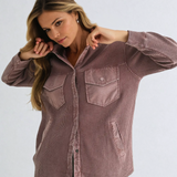 Woman wearing a brown checkered shirt against a white background