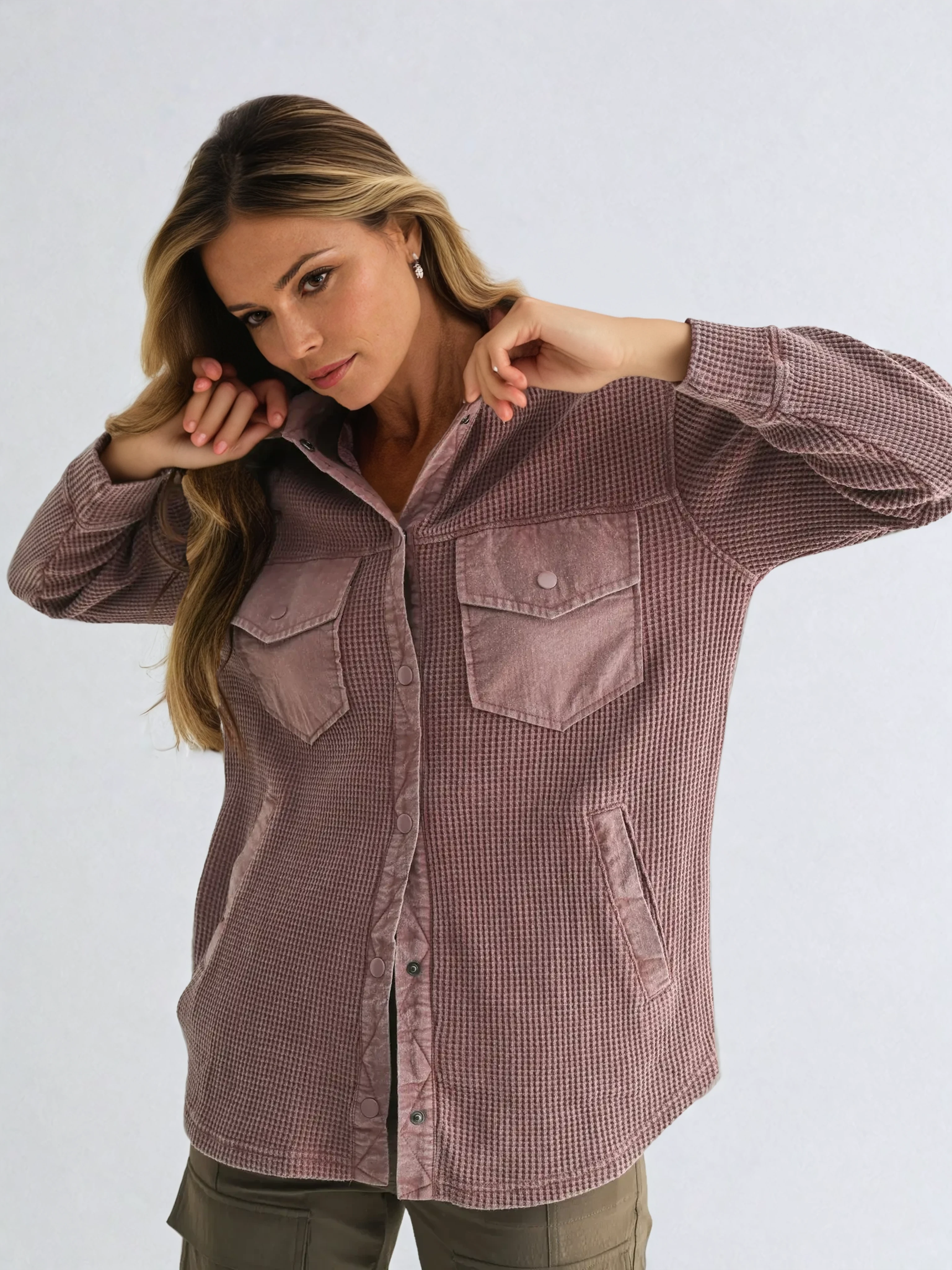 Woman wearing a brown checkered shirt against a white background