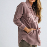 Woman wearing a pink checkered shirt with a white background