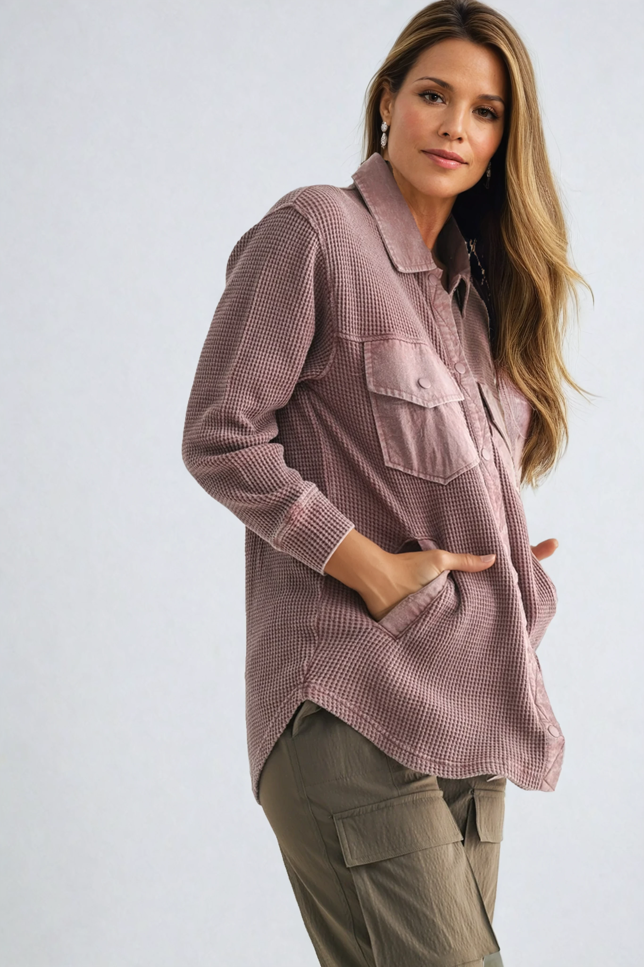 Woman wearing a pink checkered shirt with a white background