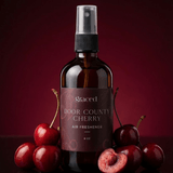 Graced Door County Cherry air freshener for home fragrance, featuring a cherry scent in a sleek container.