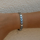Silver intention bracelet from ALCO, stylish jewelry accessory with engraved designs, perfect for everyday wear.