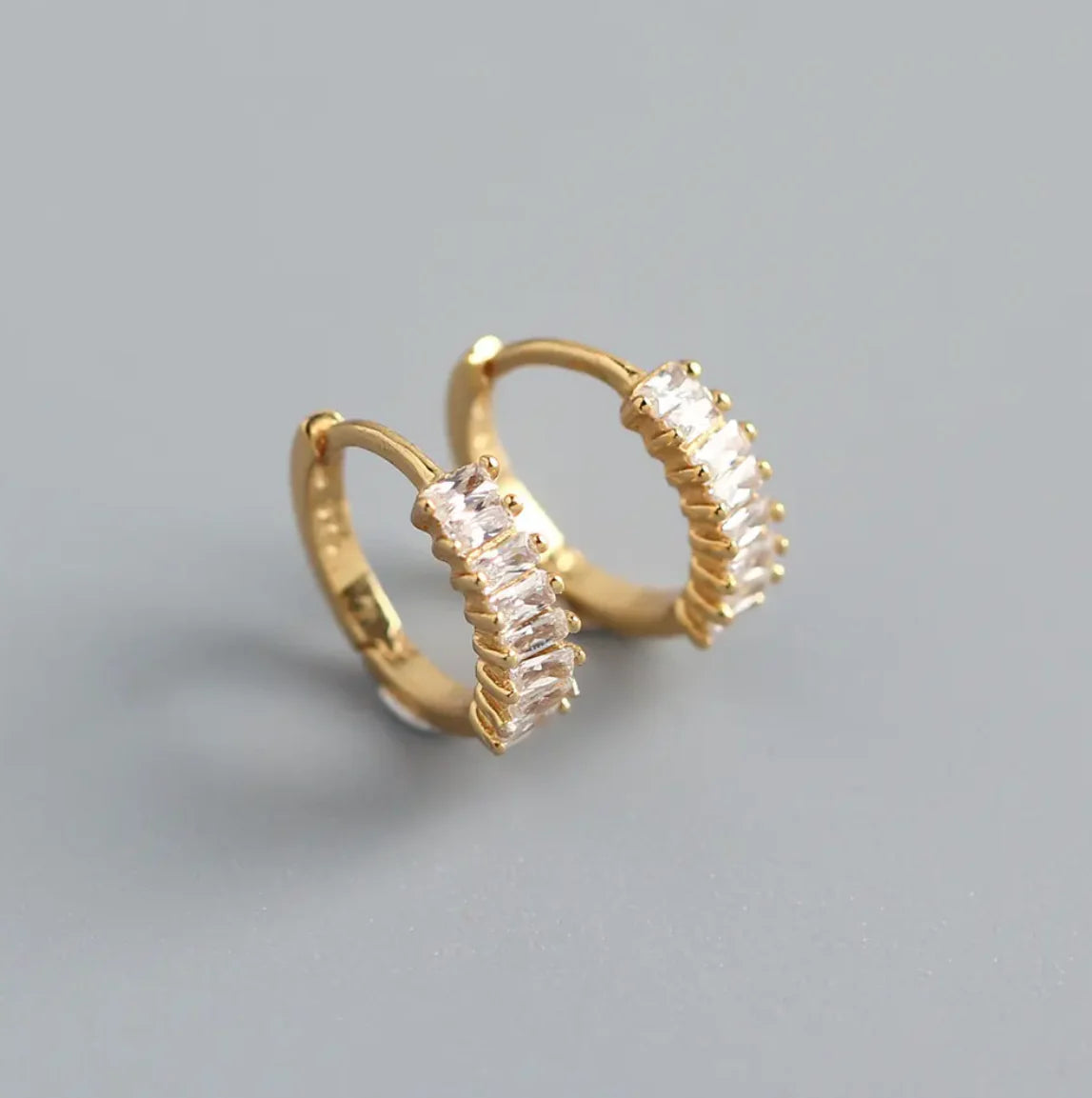 Gold Grace Huggies earrings by ALCO, small hoop jewelry accessory for pierced ears, shiny gold finish, stylish and elegant.