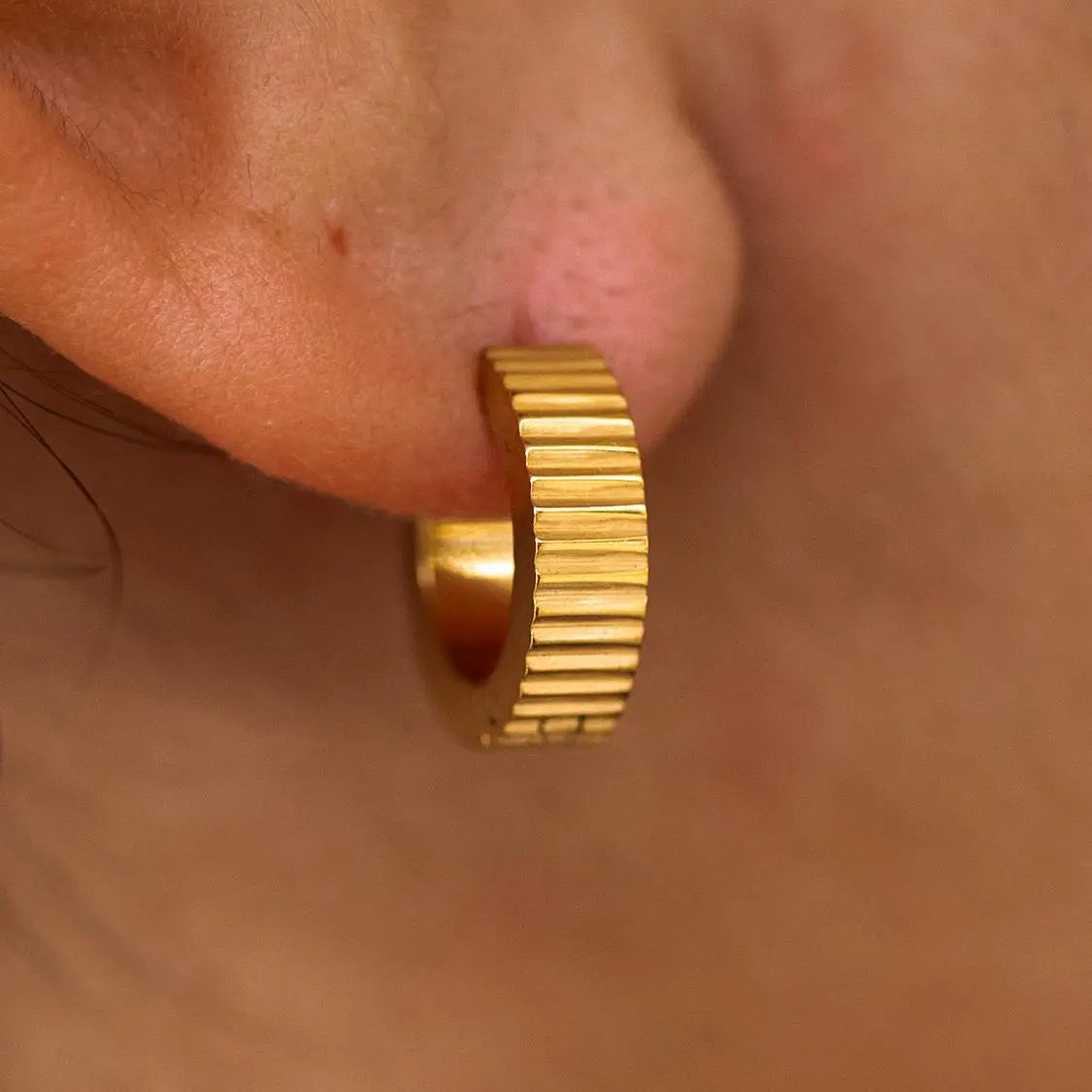 Gold Roman Huggies earrings by ALCO, stylish jewelry accessories with a classic hoop design for everyday wear.