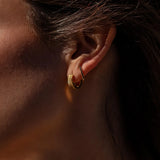 Gold Roman Huggies earrings by ALCO, small hoop jewelry accessory with a classic Roman-inspired design.