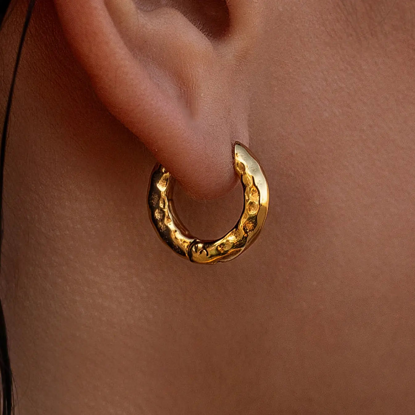 Gold Source Huggies earrings by ALCO, stylish jewelry accessory with a sleek hoop design.