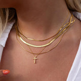 Gold cross necklace by ALCO featuring a sleek design, perfect as a jewelry accessory for everyday or special occasions.