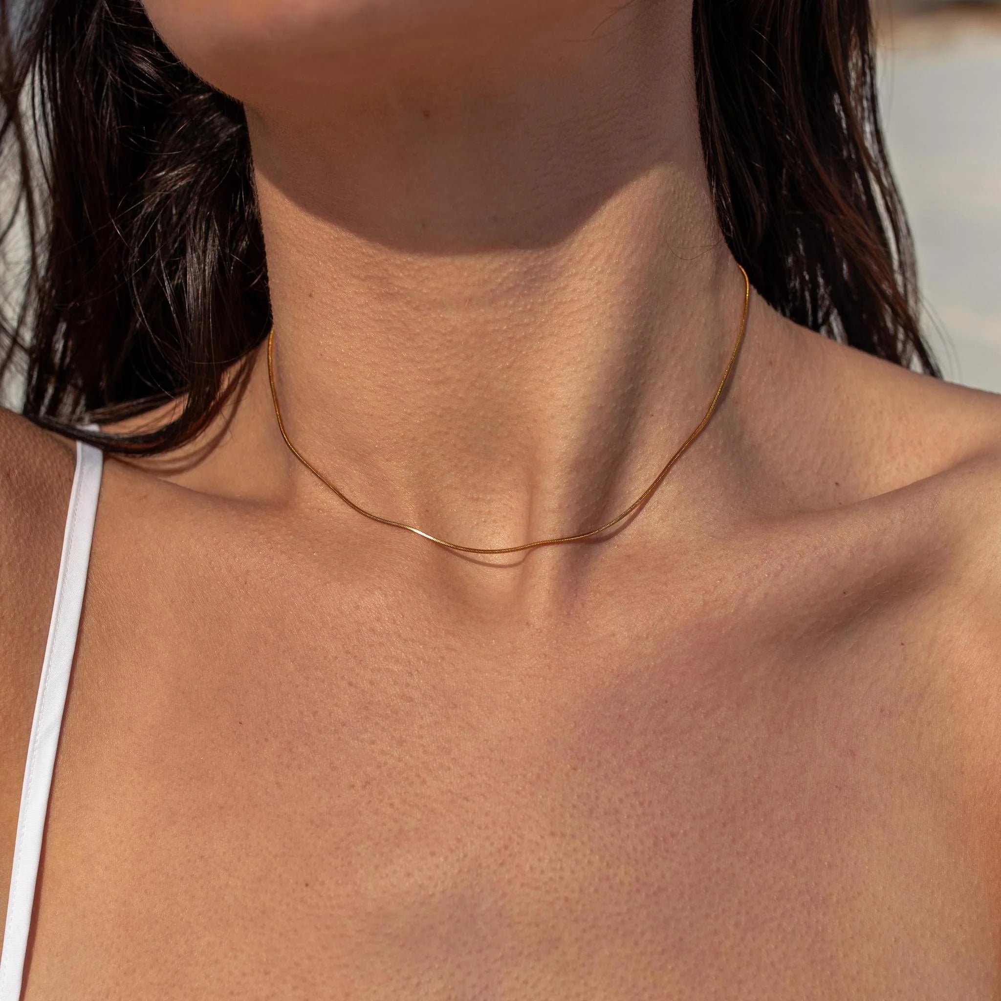 Gold Halo Necklace by ALCO featuring a delicate circular pendant, perfect for elegant jewelry accessories.