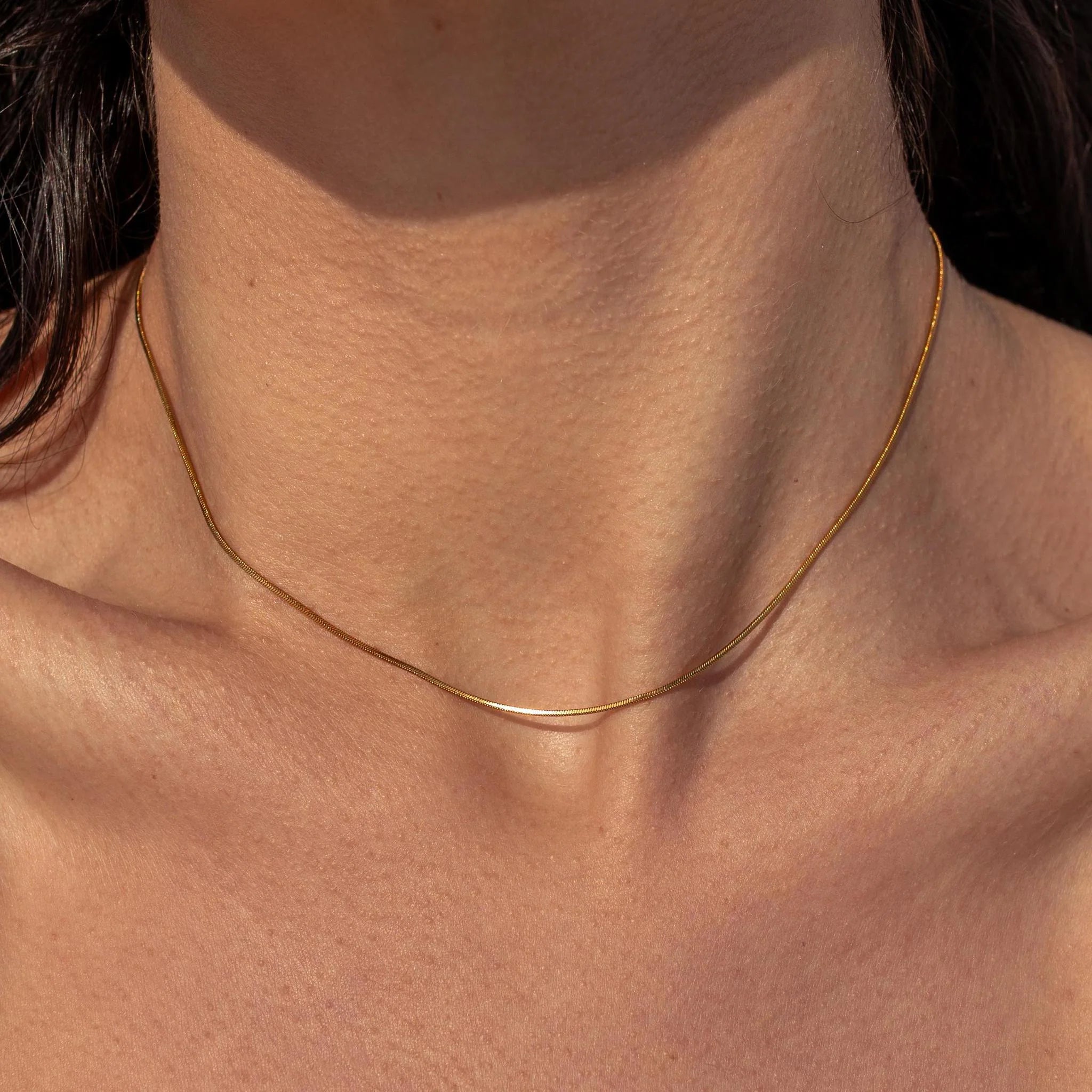Gold Halo Necklace by ALCO featuring a circular pendant, stylish jewelry accessory for elegant and everyday wear.