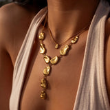 Gold Origin Necklace by ALCO, a stylish jewelry accessory featuring a delicate chain and pendant design.