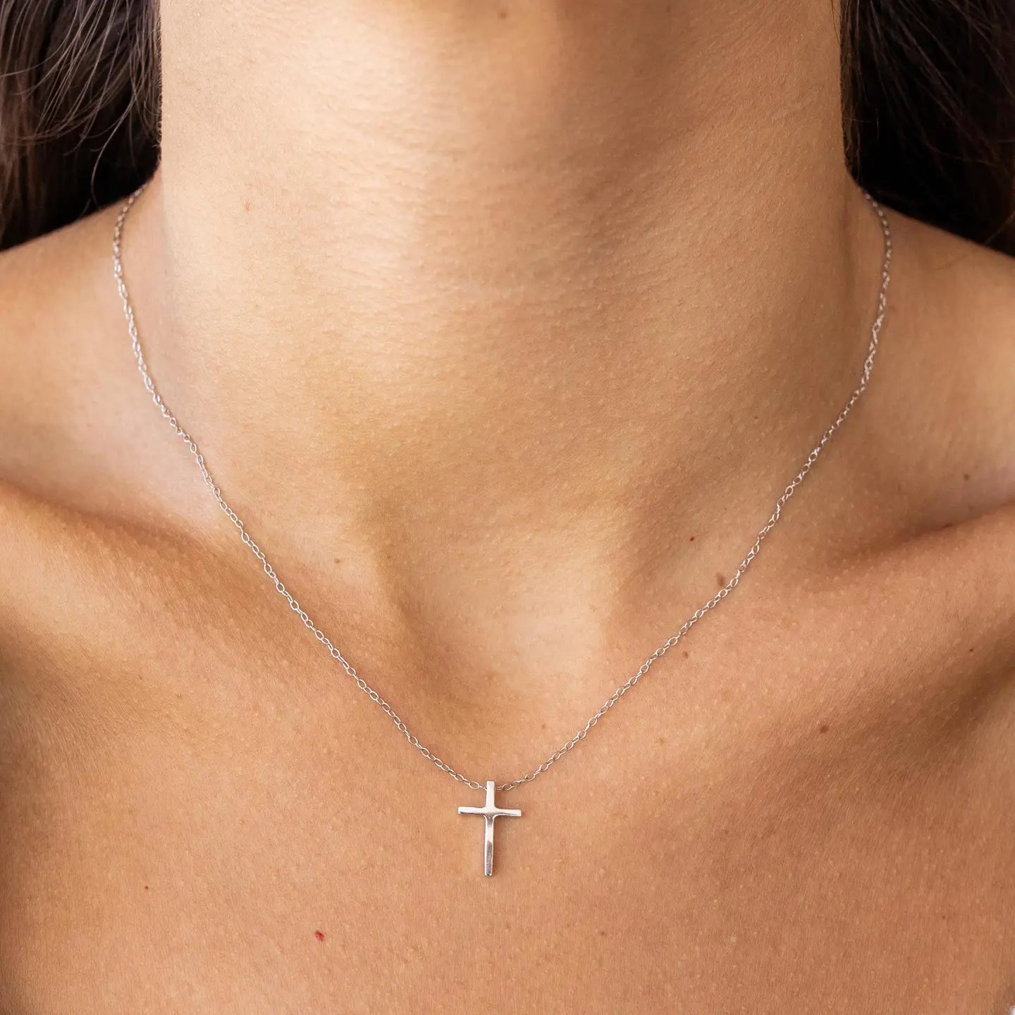 Silver cross necklace by ALCO, a stylish jewelry accessory with detailed pendant featuring a classic cross design.