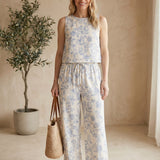 Allie Rose floral linen pants worn by a virtual model, lightweight and stylish bottoms with a colorful scattered floral pattern.