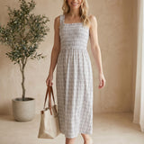 Blue plaid print smocked midi dress by Allie Rose featuring a fitted bodice and flowy skirt, perfect for casual or dressy occasions.