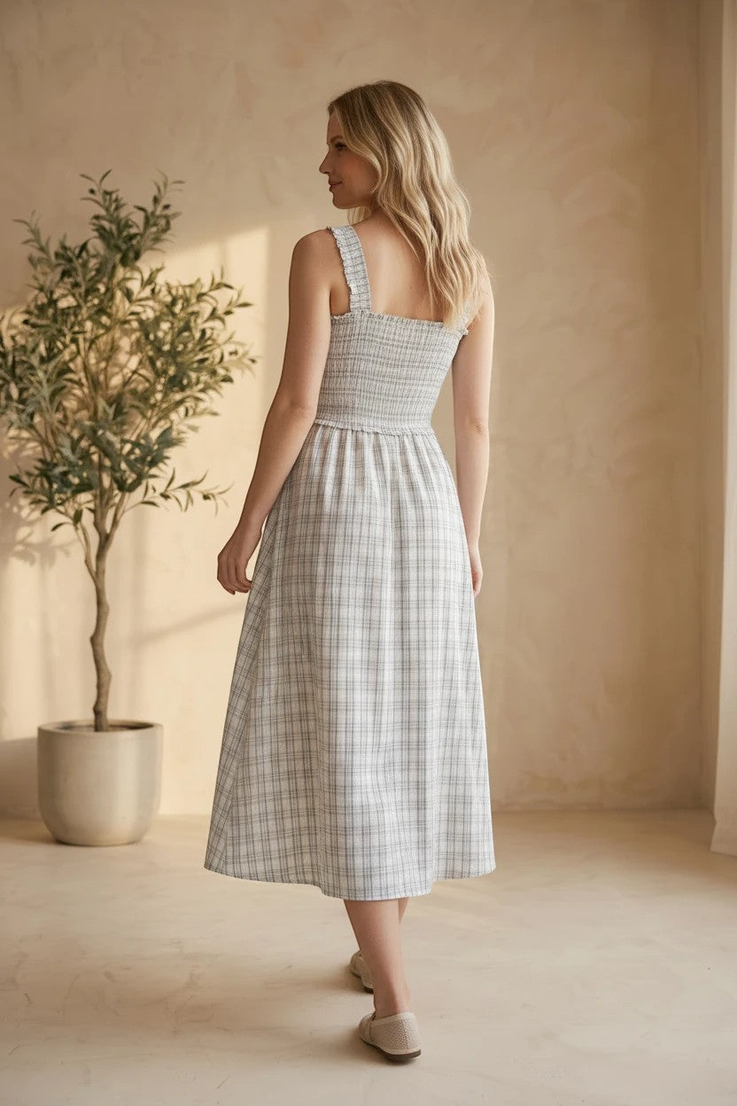 Blue plaid print smocked midi dress by Allie Rose featuring a fitted bodice and flowy skirt, perfect for casual or semi-formal wear.