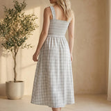 Blue plaid print smocked midi dress by Allie Rose featuring a fitted bodice and flowy skirt, perfect for casual or semi-formal wear.