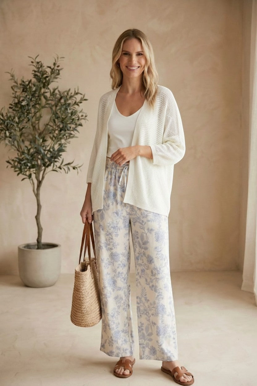Cream Be Cool Dolman Open Cardigan made of soft knit fabric, displayed on a hanger with a relaxed fit and open front design.