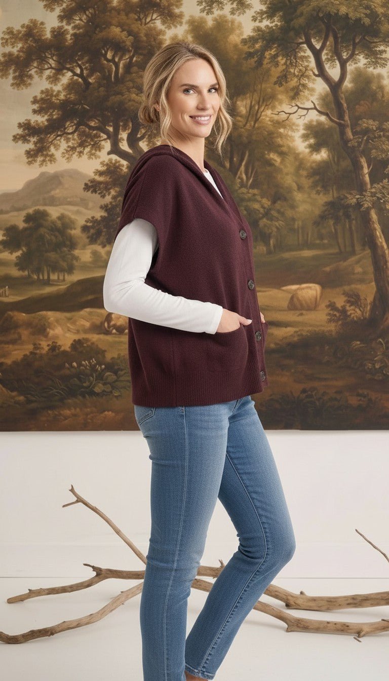 graced burgundy button down sleeveless hoodie worn by a woman with jeans and a white long sleeve top