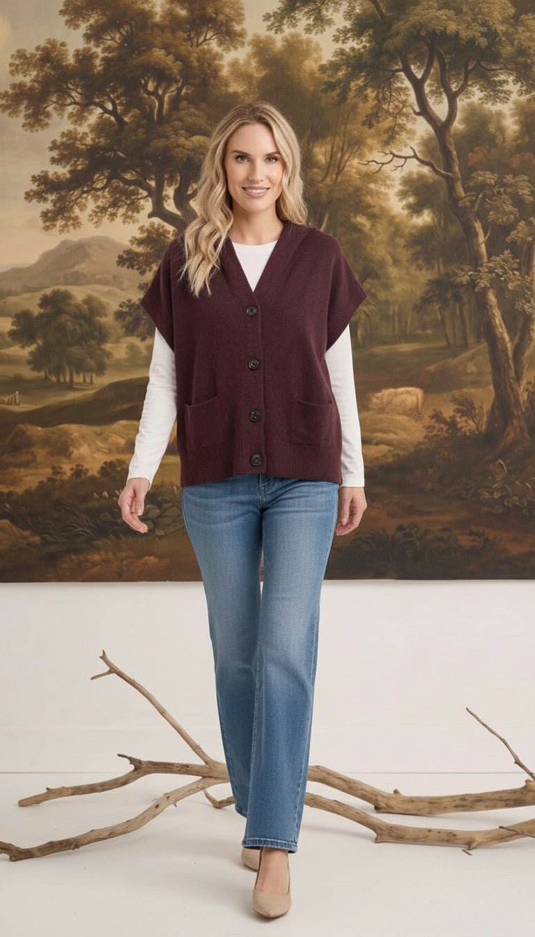 graced burgundy button down sleeveless hoodie layered over a white long sleeve top and blue jeans