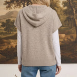 graced taupe button down hoodie top worn over a white long sleeve shirt with blue jeans, back view