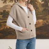 graced taupe button-down hooded vest worn by a woman over a white long-sleeve shirt and blue jeans