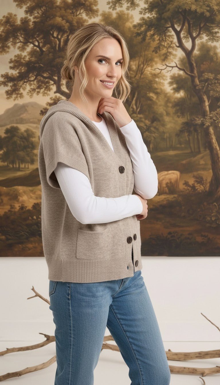 graced taupe button down hooded vest worn by a woman over a white long sleeve shirt with blue jeans