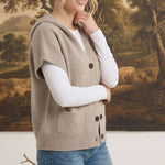 graced taupe button down hooded vest worn by a woman over a white long sleeve shirt with blue jeans