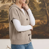 graced taupe button down hooded vest worn by a woman over a white long sleeve shirt with blue jeans