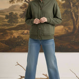 Model wearing a graced olive mock neck button-down cardigan with front pockets, styled with blue jeans and heels.