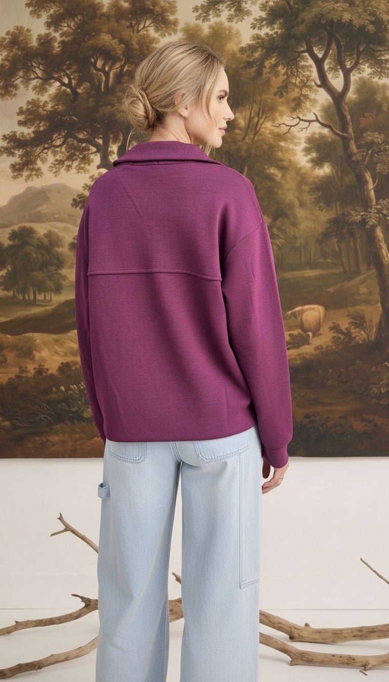 Back view of a woman wearing a wine-coloured graced mock neck cardigan with a relaxed fit and button-down detail.