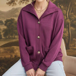 graced wine mock neck button down cardigan with front pockets worn by a blonde model in a relaxed fit