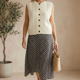 Be Cool cable knit sweater vest, cream-colored knit top with ribbed edges and a classic cable pattern displayed on a neutral background.