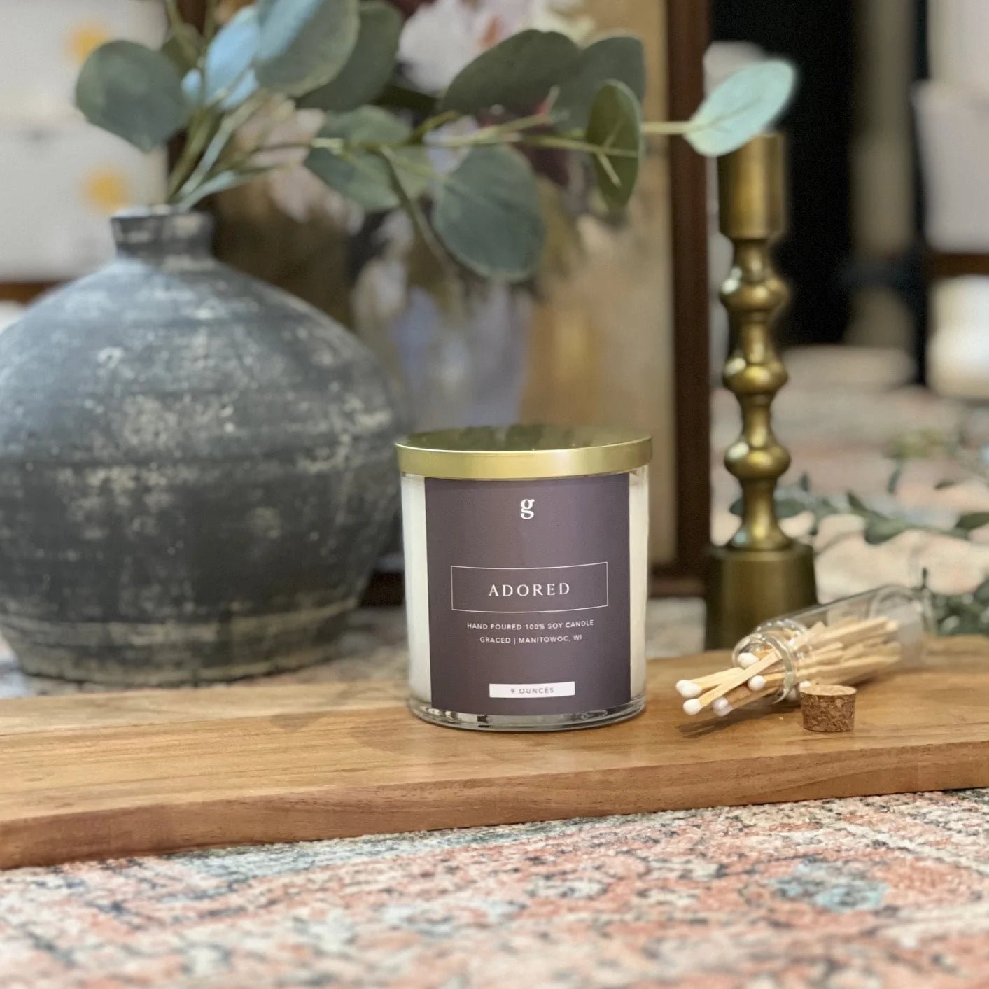 Mini scented candle from graced's Adored collection, featuring a sleek glass holder and soft, warm glow for home fragrance.