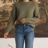graced chunky olive green crewneck sweater with a relaxed knit texture worn with blue jeans