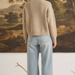 graced mushroom crew neck cardigan worn by a woman with blonde hair in a bun, paired with light wash wide leg jeans