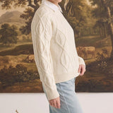 graced cream cable knit crew neck sweater worn by a woman with a white collared shirt and light blue jeans