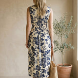 Navy floral V-neck smocked waist midi dress from Doe and Rae featuring a flowy silhouette and elegant design.