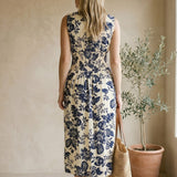 Navy and ivory V-neck smocked waist midi dress by Doe and Rae, featuring a flowy silhouette and elegant design.